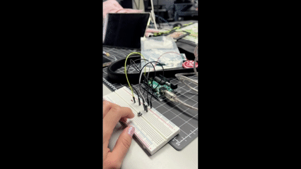 We introduced a button, removed one led and one resistor, kept 3 ground wires, and 2 live wires to complete the circuit